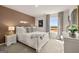 Modern bedroom with earth-tone accent wall, decorative lighting, new window treatments, and ample light at 596 Whitman Lane # 2025, Stockbridge, GA 30281