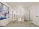 Upstairs hallway view with a large blue painting, white doors, and access to the stairwell at 596 Whitman Lane # 2025, Stockbridge, GA 30281