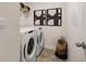 A clean laundry room featuring a side-by-side washer and dryer, art and a storage basket at 596 Whitman Lane # 2025, Stockbridge, GA 30281