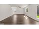 Open concept living room with fan and hardwood floors, with view of the staircase and backyard at 596 Whitman Lane # 2025, Stockbridge, GA 30281
