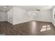 View of the living area with hardwood floors, overhead lighting, and a glimpse of the staircase at 596 Whitman Lane # 2025, Stockbridge, GA 30281