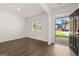 Bright and open living room with hardwood floors, a large window, and a view of the front yard at 596 Whitman Lane # 2025, Stockbridge, GA 30281