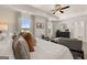 Comfortable main bedroom features a king bed, seating, and a view of the neighborhood at 596 Whitman Lane # 2025, Stockbridge, GA 30281