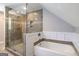 Beautifully renovated bathroom features a glass-enclosed shower and a soaking tub at 250 Hester Rd, Carrollton, GA 30116
