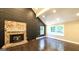 Bright living room featuring a stone fireplace, wood floors, and a vaulted ceiling at 250 Hester Rd, Carrollton, GA 30116
