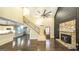 Open-concept living room showcasing hardwood floors, staircase, stone fireplace, and natural light at 250 Hester Rd, Carrollton, GA 30116