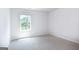 Well-lit bedroom featuring soft carpet and a clear window view at 592 Whitman Ln # 2024, Stockbridge, GA 30281