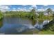 Scenic pond view with lush green trees and surrounding community homes on a sunny day at 592 Whitman Ln # 2024, Stockbridge, GA 30281