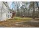 Backyard with grass, swing set, shed, and many trees at 75 Bretts Bnd, Sharpsburg, GA 30277