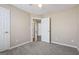 This bedroom features neutral paint, carpet, and an entranceway to another part of the house at 75 Bretts Bnd, Sharpsburg, GA 30277