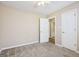 Well-lit bedroom features neutral paint, carpet, a ceiling fan, and white doors at 75 Bretts Bnd, Sharpsburg, GA 30277