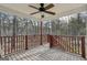 Outdoor deck features a ceiling fan and a beautiful wooded view at 75 Bretts Bnd, Sharpsburg, GA 30277