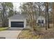 Inviting single-story home featuring an attached garage and mature trees in a natural setting at 75 Bretts Bnd, Sharpsburg, GA 30277