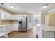 Eat-in kitchen with white cabinetry and stainless appliances, ready for cooking and entertaining at 75 Bretts Bnd, Sharpsburg, GA 30277