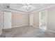 This main bedroom features two closets, an ensuite, a ceiling fan, and carpet at 75 Bretts Bnd, Sharpsburg, GA 30277