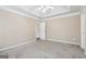 This is a spacious main bedroom with neutral walls, carpet, ceiling fan, and crown molding at 75 Bretts Bnd, Sharpsburg, GA 30277