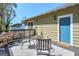 Outdoor back porch offers seating, plants, and a blue door, creating a cozy space for relaxation at 988 Allene Sw Ave, Atlanta, GA 30310