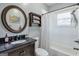 Well-maintained bathroom featuring granite counters, shower-tub combo and decorative accents at 988 Allene Sw Ave, Atlanta, GA 30310