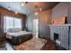 Cozy bedroom with decorative brick fireplace, patterned rug and ample sunlight at 988 Allene Sw Ave, Atlanta, GA 30310