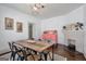 A bright dining room shows a painted brick fireplace and a rustic wooden dining table at 988 Allene Sw Ave, Atlanta, GA 30310