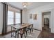 Open dining room with wooden table, neutral walls, and large windows with bright natural light at 988 Allene Sw Ave, Atlanta, GA 30310