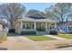 Inviting craftsman-style home featuring a covered porch and a neat yard with green grass at 988 Allene Sw Ave, Atlanta, GA 30310