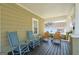 Comfortable front porch with rocking chairs, painted wood, and a view of the neighborhood at 988 Allene Sw Ave, Atlanta, GA 30310