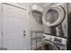 Functional laundry area featuring stacked washer and dryer units and ample space for storage at 988 Allene Sw Ave, Atlanta, GA 30310