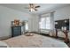 Bright main bedroom featuring a ceiling fan, window with patterned curtains, and modern furnishings at 988 Allene Sw Ave, Atlanta, GA 30310