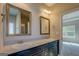 Bathroom features dual sinks with framed mirrors, vanity, and access to other rooms at 509 Cowpens Rd, Social Circle, GA 30025