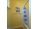 Bathroom with yellow walls and shower/tub combo with blue and white striped curtain at 509 Cowpens Rd, Social Circle, GA 30025