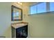 Bathroom vanity features a granite countertop, decorative mirror, and updated fixtures under a bright window at 509 Cowpens Rd, Social Circle, GA 30025