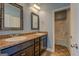 Bathroom features dual sinks with framed mirrors, dark vanity and a full bathtub/shower at 509 Cowpens Rd, Social Circle, GA 30025