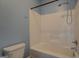 Cozy bathroom with a shower-tub combo, blue walls, and standard toilet at 509 Cowpens Rd, Social Circle, GA 30025