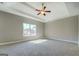 Bedroom features plush carpet, a modern ceiling fan, and a large window for natural light at 509 Cowpens Rd, Social Circle, GA 30025