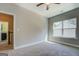 Bright bedroom with neutral walls, carpet, ceiling fan, and an ensuite bathroom at 509 Cowpens Rd, Social Circle, GA 30025