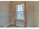 Bright walk-in closet features sturdy wire shelving and a window for natural light at 509 Cowpens Rd, Social Circle, GA 30025