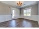 Dining room with wood flooring, wainscoting, chandelier and a large window at 509 Cowpens Rd, Social Circle, GA 30025