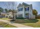 Charming two-story home with light green siding, dark shutters, and a well-manicured lawn on a sunny day at 509 Cowpens Rd, Social Circle, GA 30025