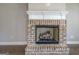 Close up of a brick fireplace with a decorative mantle and wooden logs at 509 Cowpens Rd, Social Circle, GA 30025