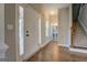 Spacious foyer featuring hardwood floors, a staircase, and a glimpse into an adjacent powder room at 509 Cowpens Rd, Social Circle, GA 30025