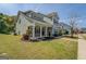 Craftsman-style home with a cozy front porch, green lawn, and tasteful landscaping in a suburban setting at 509 Cowpens Rd, Social Circle, GA 30025