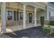 Spacious covered front porch with white columns, dark shutters, and a welcoming wreath on the front door at 509 Cowpens Rd, Social Circle, GA 30025
