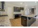 Kitchen with black cabinets, granite countertops, stainless steel appliances, and hardwood floors at 509 Cowpens Rd, Social Circle, GA 30025