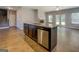 Spacious kitchen island with granite countertops, dark wood cabinets, and stainless steel dishwasher at 509 Cowpens Rd, Social Circle, GA 30025
