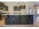 Kitchen island with black cabinets, granite countertops, and stainless steel faucet at 509 Cowpens Rd, Social Circle, GA 30025
