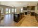 Open-concept kitchen featuring dark cabinets, a granite island, and stainless steel appliances at 509 Cowpens Rd, Social Circle, GA 30025