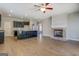 Open concept living room and kitchen with hardwood floors and brick fireplace at 509 Cowpens Rd, Social Circle, GA 30025
