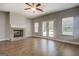 Living room featuring a brick fireplace, hardwood floors, and double doors at 509 Cowpens Rd, Social Circle, GA 30025