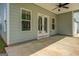 Covered outdoor patio features ceiling fan, and leads to a 2-car garage at 509 Cowpens Rd, Social Circle, GA 30025